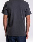 Back view of a person wearing a dark gray t-shirt on a white background